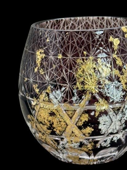 Close-up of the red cut glass tumbler with gold and silver leaf