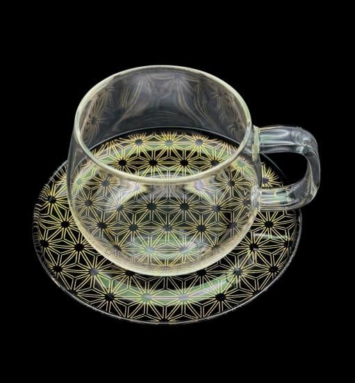 Asanoha jet black makie saucer with a clear glass cup, closer view