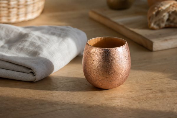 Editorial wooden egg cup on a kitchen table with a soft cloth