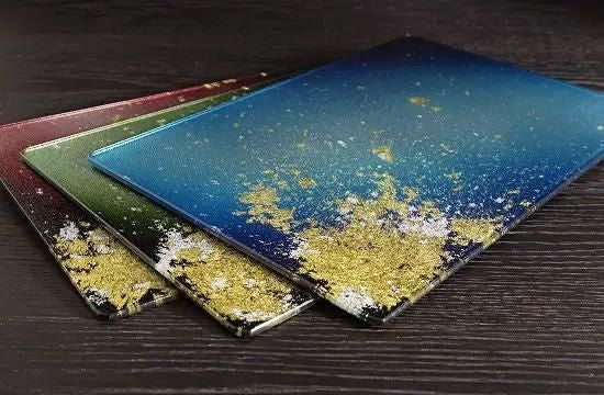 Three gradient plates in blue, green and red with gold leaf