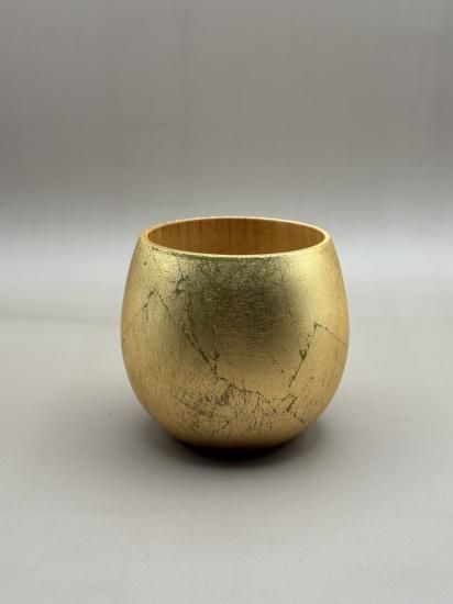 Wooden egg cup with gold leaf, angled view